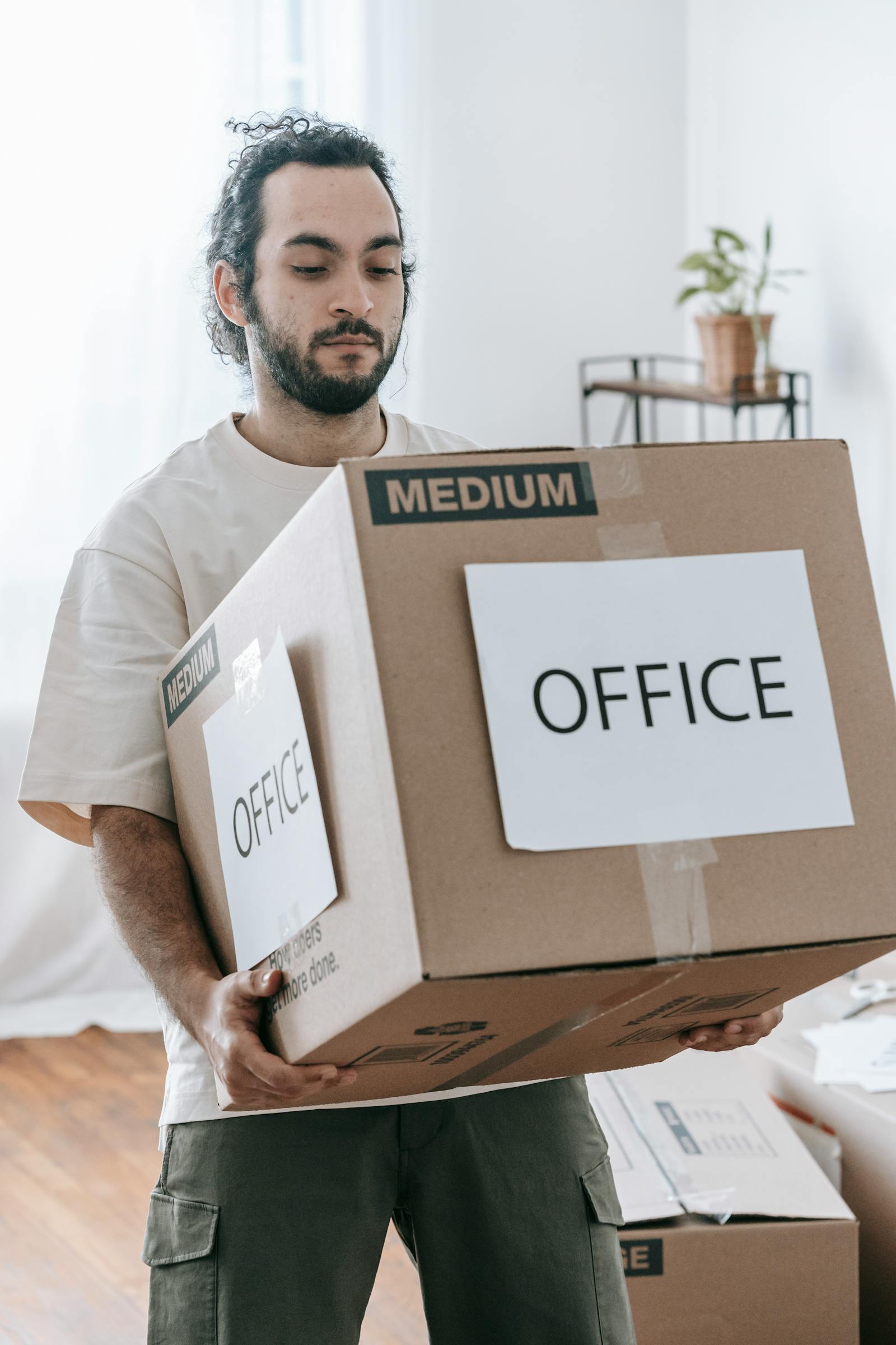 Businessman moving office in Pretoria with desks, files, and office boxes being relocated